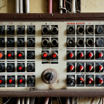 **Prompt:** A dilapidated, old electrical panel in a Russian apartment building, showing frayed wires and signs of wear. Focus on the danger and potential fire hazard. Dark, gritty, realistic.